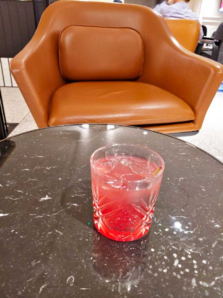 A padded chair, not quite an armchair, but more comfortable than a chair. Qantas lounge London Heathrow.